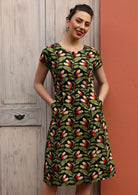 Model wears green and black cotton dress with pockets