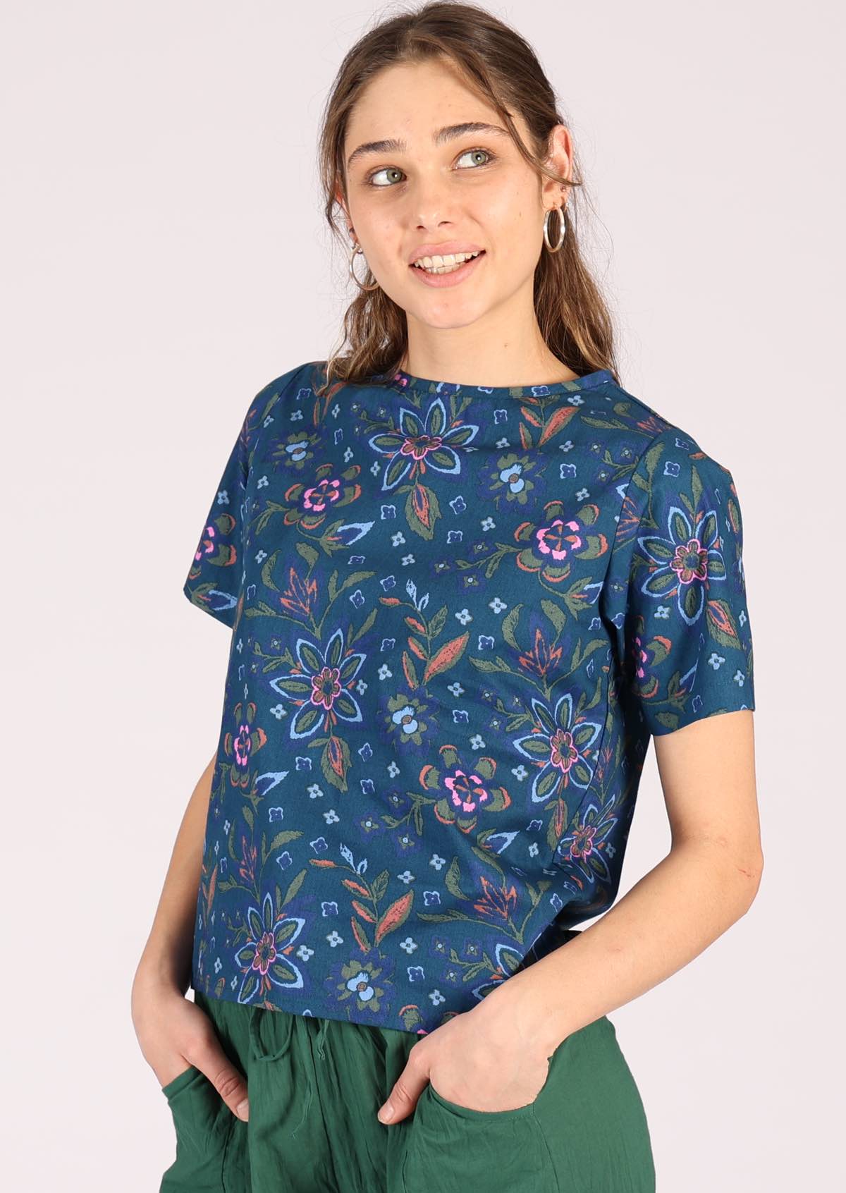 Model wears 100% cotton top with a floral pattern. 