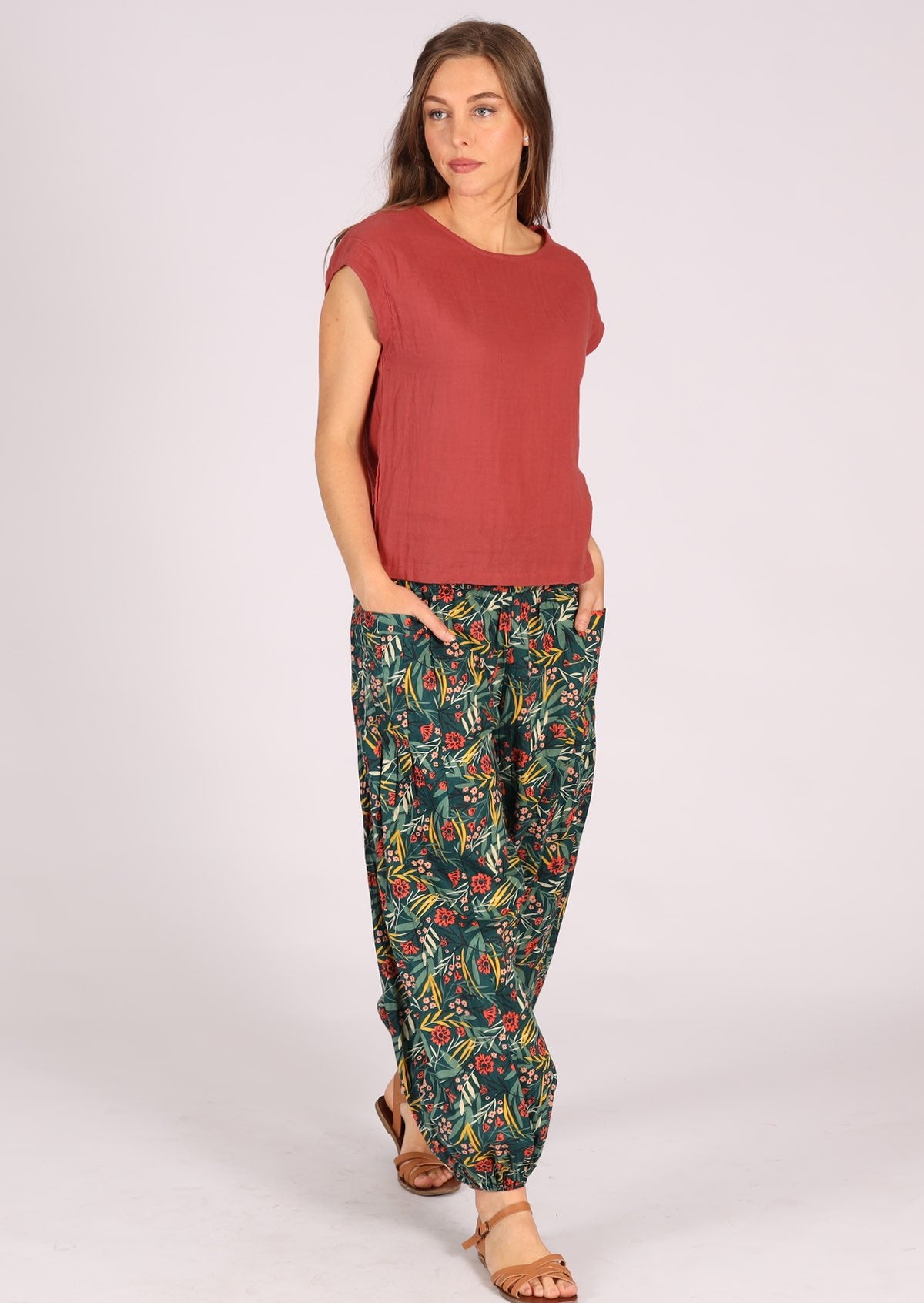Woman wearing green cotton floral pants with pink top