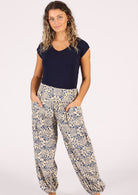Model poses in cotton pants with pockets and wide waist yoke
