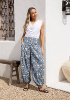Models stands in sun wearing a 100% cotton harem style pants with elasticated waist and ankles