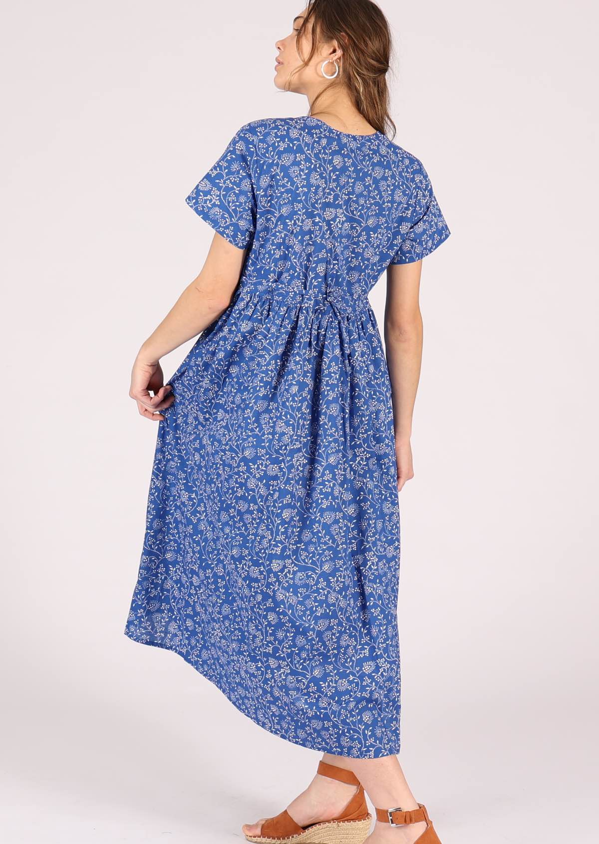 Model wears cotton button through relaxed fit dress with shoestring side ties