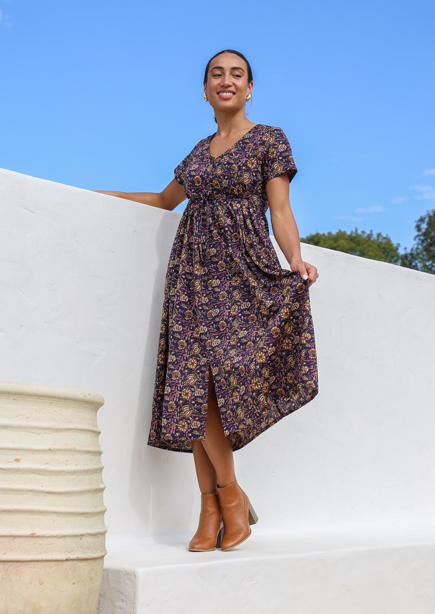 Model wears lightweight, relaxed fit cotton maxi dress with floral print, short sleeves, waist tie and pockets.
