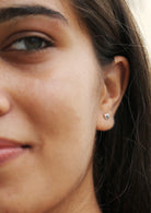 Woman wearing sterling silver Quadruple Ripple studs with secure butterfly backs