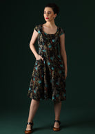 Model wears over the knee cotton retro dress with round neckline