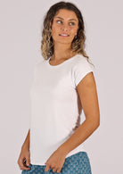 Woman with curly blonde hair wearing a soft flattering fit white rayon jersey t-shirt.