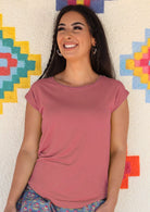Woman wearing a soft flattering fit pink rayon jersey t-shirt.