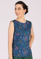 Model wears a tailored  blue floral 100% cotton top that sits on the hip bone. 