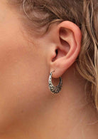 silver boho hoop earrings on woman's ear