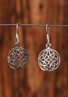 92.5% silver circular Celtic style earrings on a wire for display.