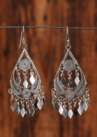 92.5% silver gypsy style teardrop earrings sitting on a wire for display.
