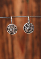 92.5% silver Celtic style earrings on a wire for display.