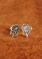 92.5% silver delicate flower earrings on wood for display.