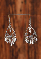 92.5% silver gypsy style diamond shaped earrings on a wire for display.