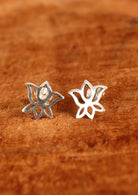 92.5% silver lotus shaped studs on wood for display.