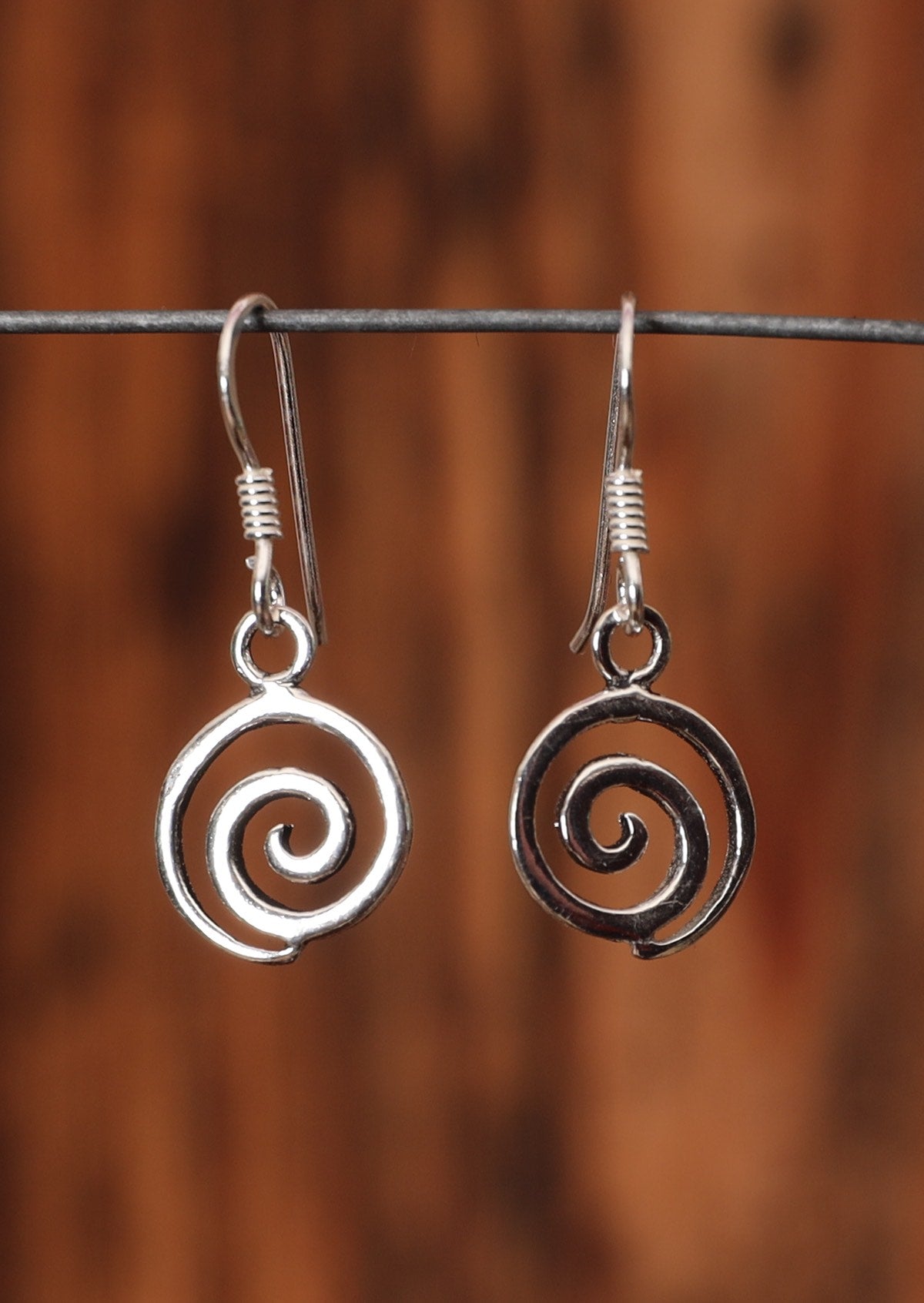 92.5% silver spiral earrings with a hook on wire for display.