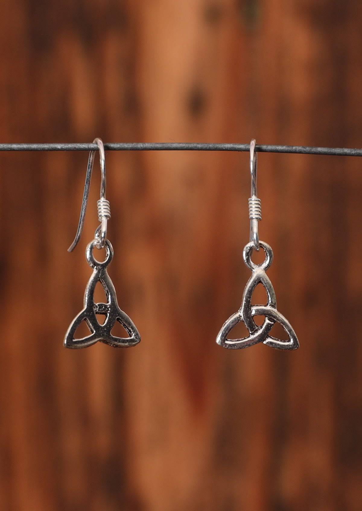 92.5% silver Triquetra earrings on a wire for display.