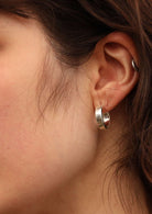 92.5% silver small thick hoop earring on model with dark hair