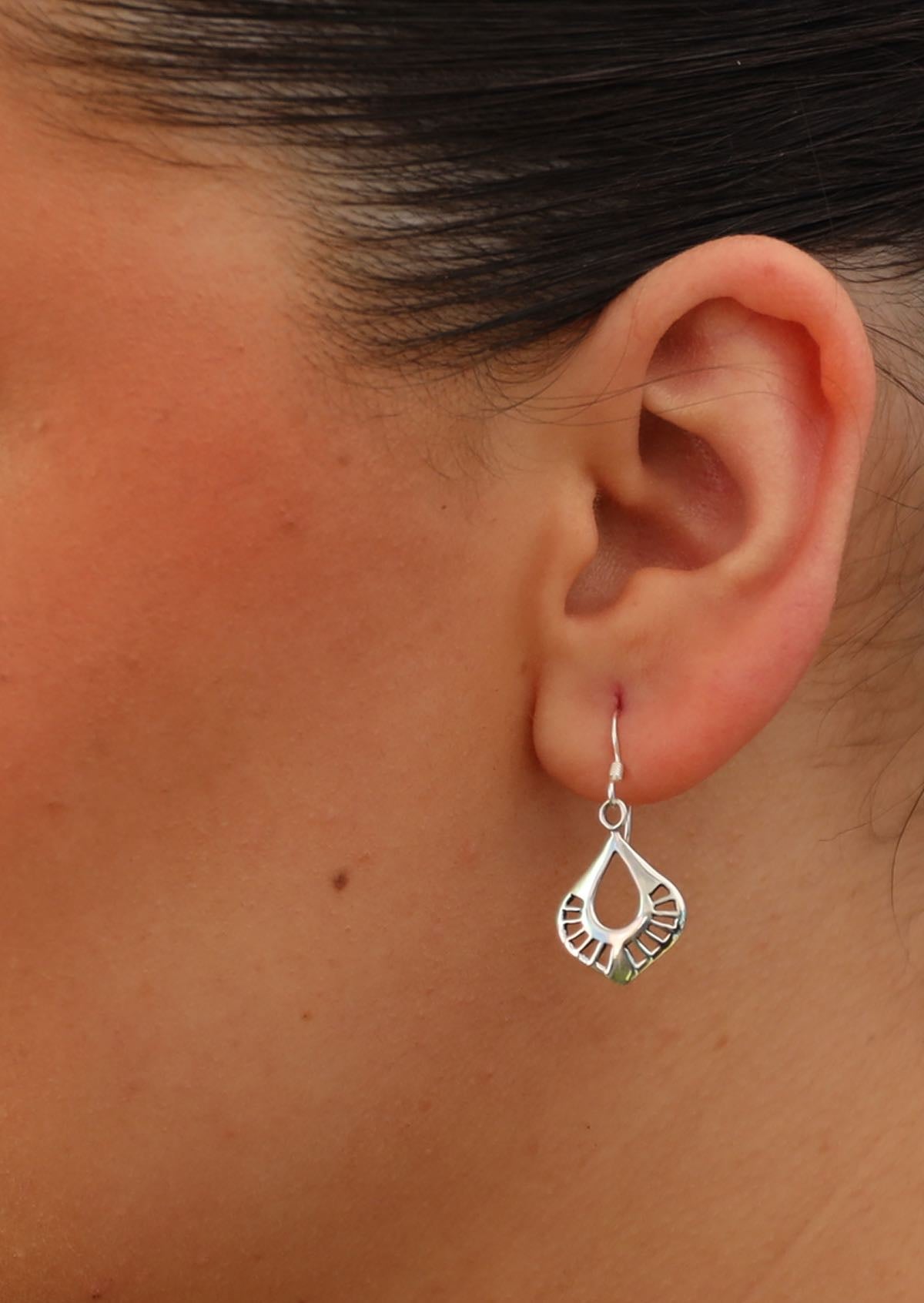 art nouveau style dangly earring on woman's ear