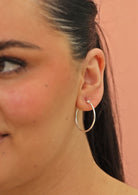 silver hoop earrings on woman