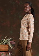 Side view of model in cream floral Sophia Blouse in Liberty print 