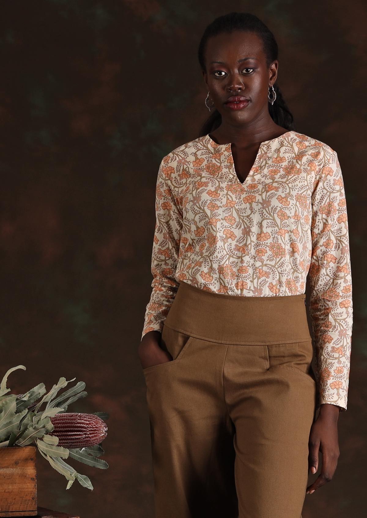 Model in cream floral Sophia Blouse in Liberty print  worn with light tan cotton pants