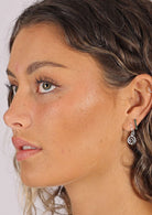 woman wearing silver spiral earrings