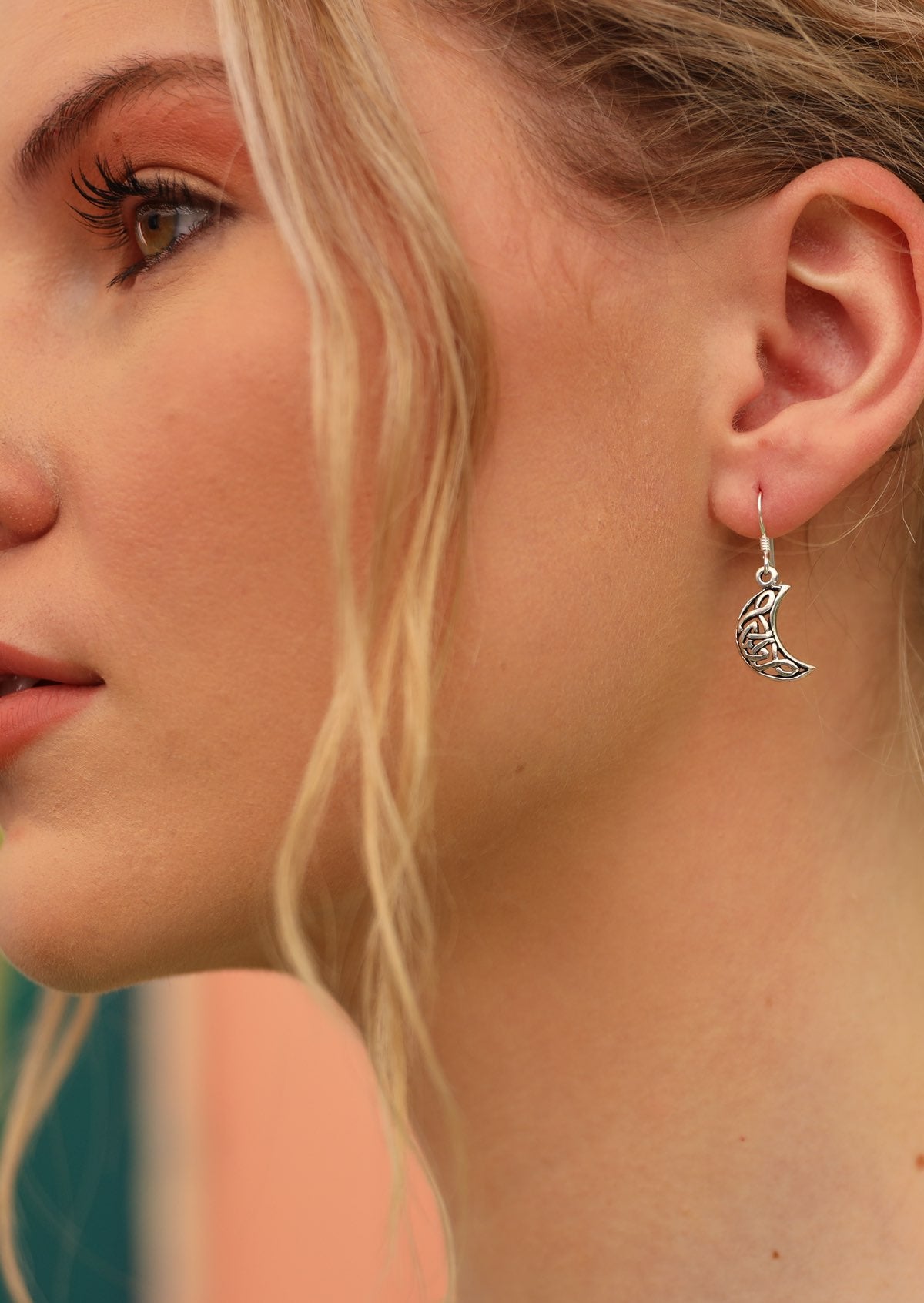 Model wears sterling silver celtic crescent moon hook earrings