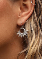 woman's ear with sun inspired boho silver earring