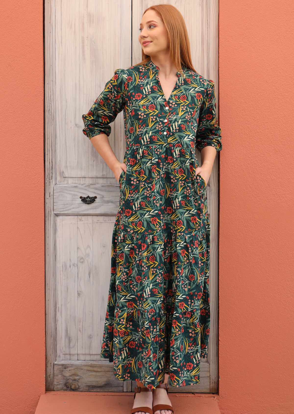 Smiling model pairs three tiered maxi dress with sandals. 