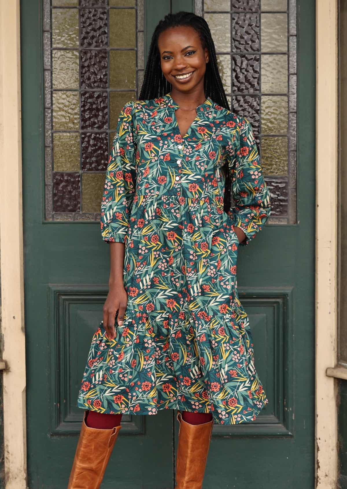 Green cotton floral dress on woman standing in doorway