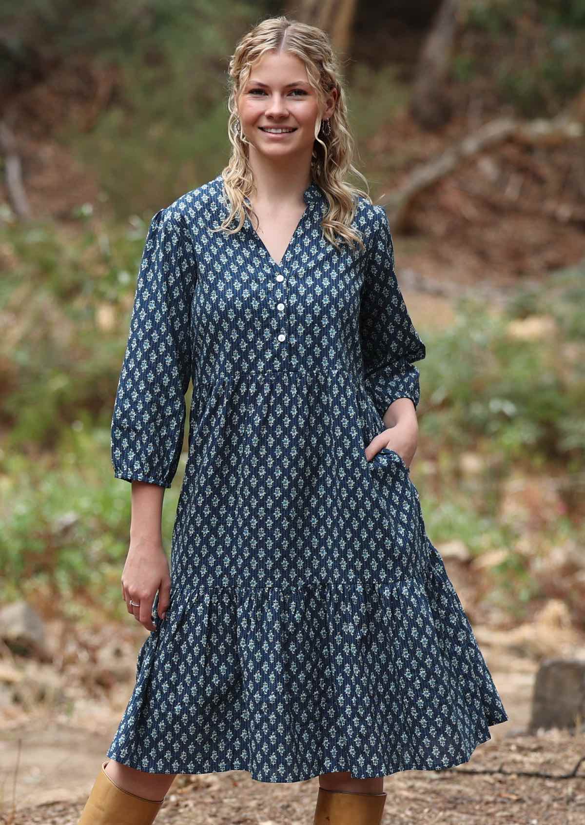 Midi length cotton dress with 3/4 sleeves and side pockets in blue base floral print