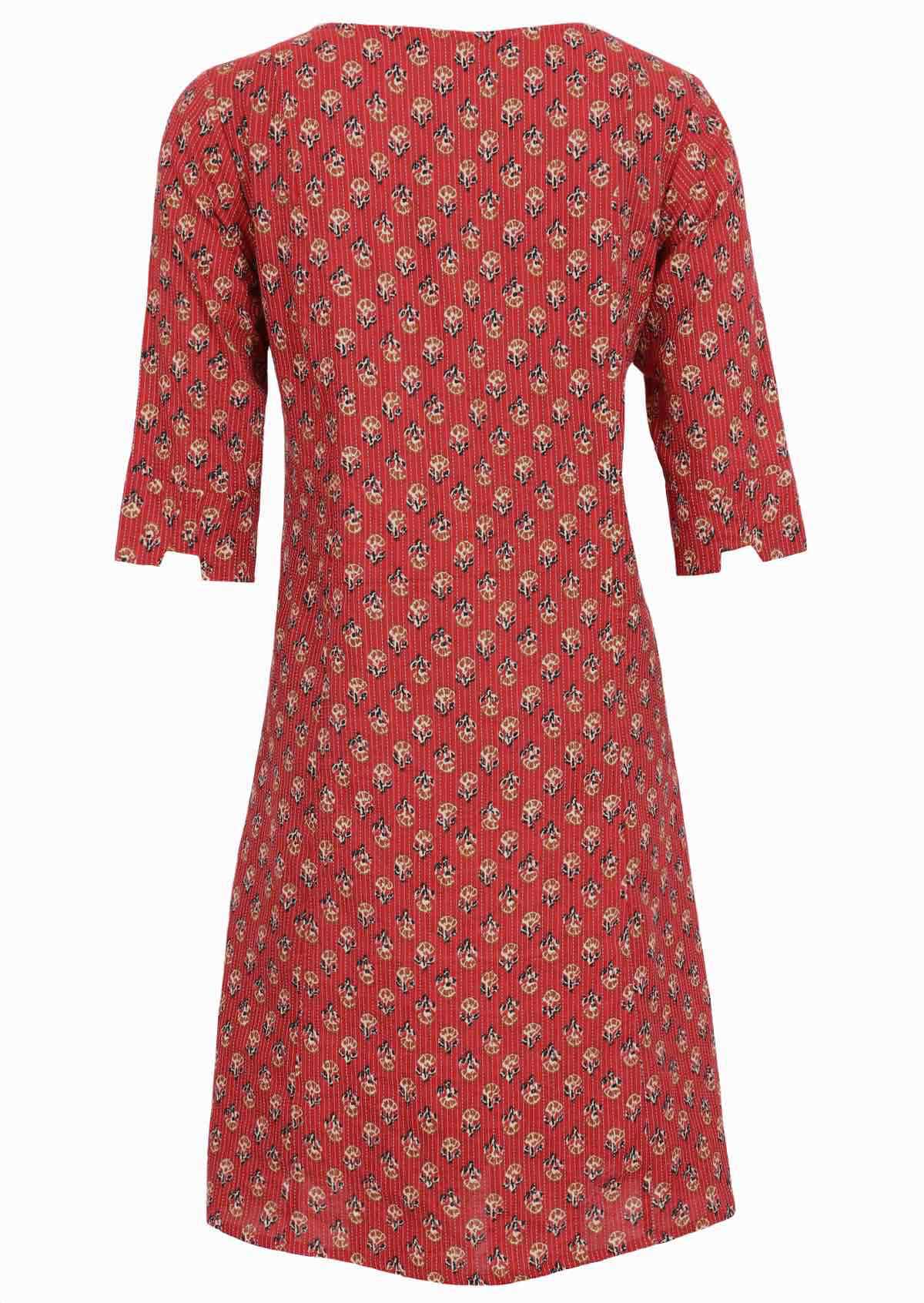 Loose fit cotton dress has a black floral print on burnt red base