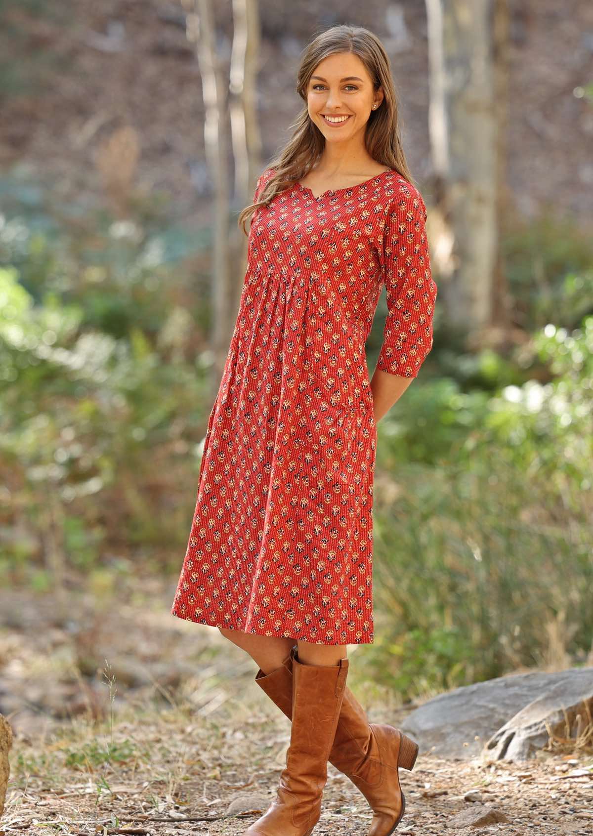 Model pairs 3/4 sleeve cotton dress with boots. 