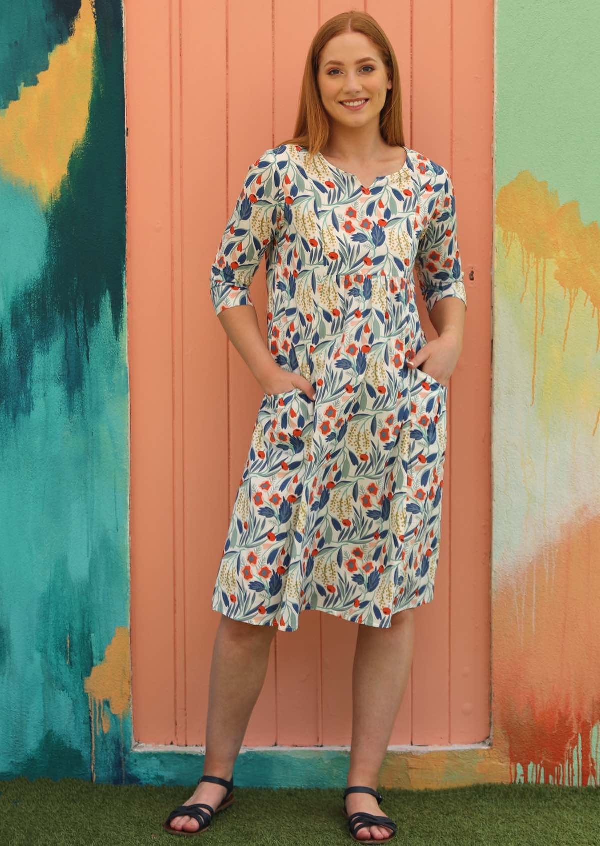 Model wears cotton floral dress with round neck and 3/4 sleeves