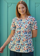 Model wears cotton floral print top with round neck and short sleeves