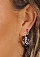 woman's ear with silver Celtic style hook earring 