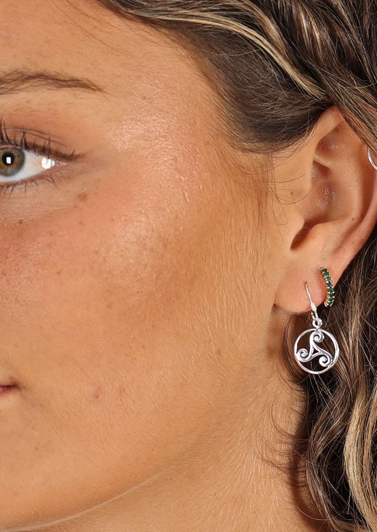 woman wearing silver Celtic style hook earring 