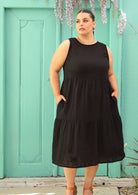 Curvy woman wearing below knee cotton black dress