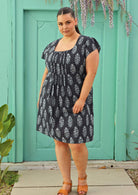 navy blue cotton dress with lining on plus sized model wearing yellow sandals