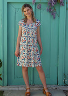 Model wears cotton floral print above knee dress