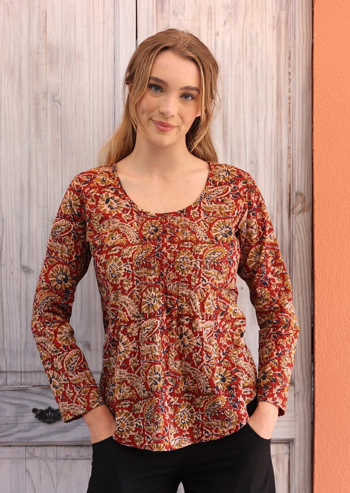 Woman wearing long sleeve red Indian cotton blouse