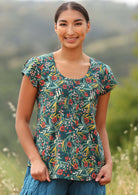 Model wears cotton top with a u-shaped neckline. 