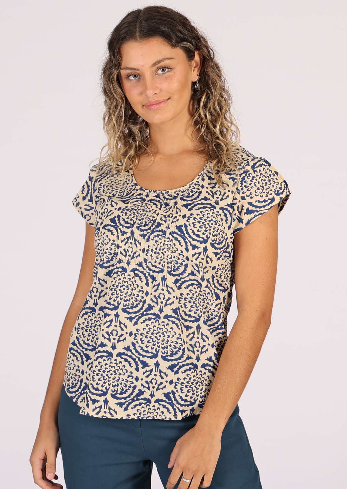 Model wears sweet cotton top with blue floral print on cream base