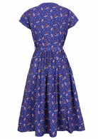 Retro style dress is 100% cotton with a blue base featuring an off white and orange daisy print.