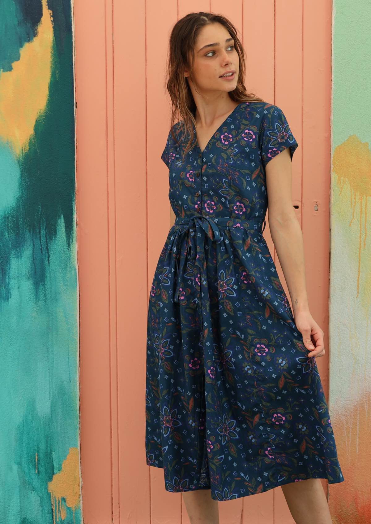 Blue cotton dress is styled with a v-neck collar. 
