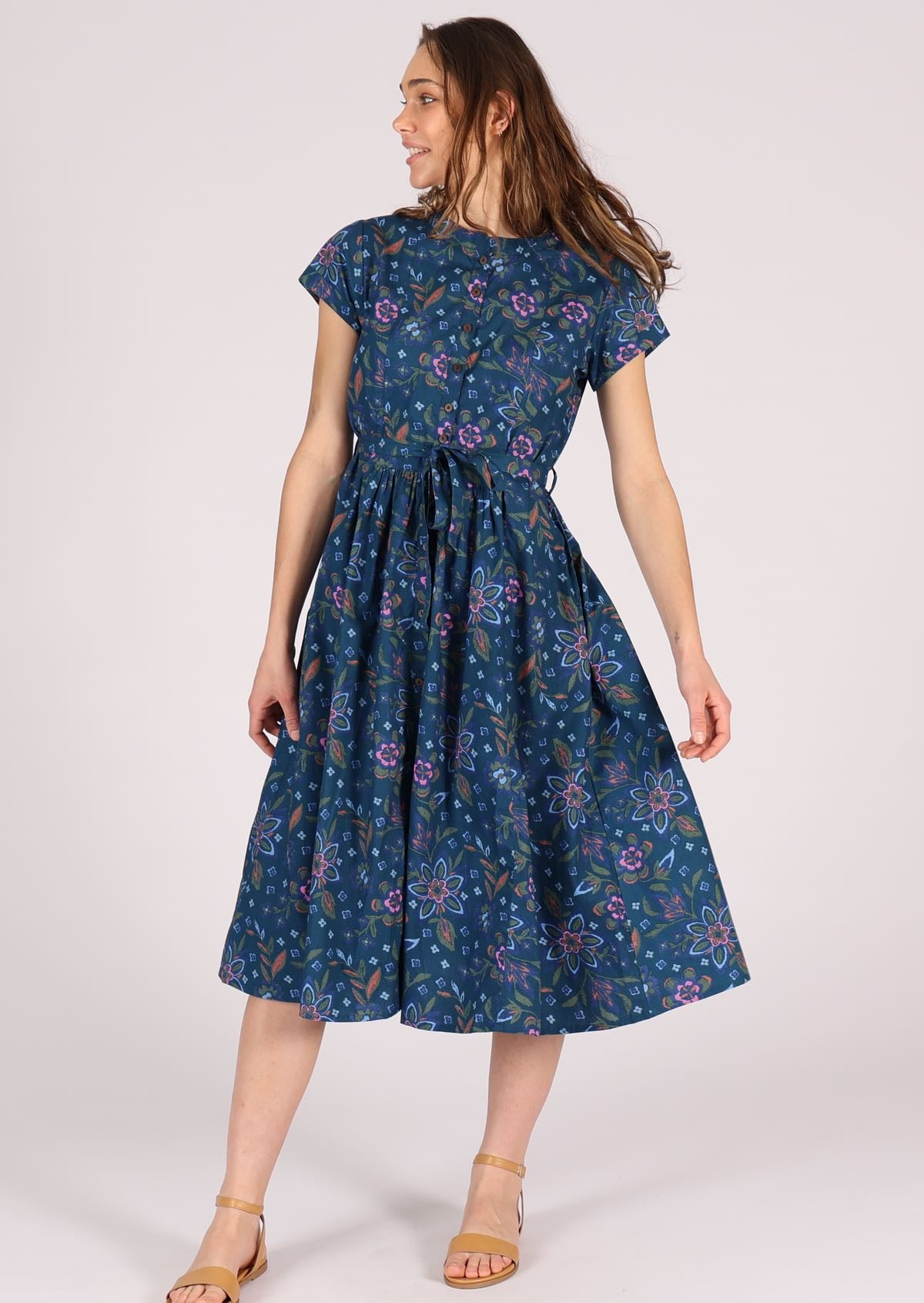 100% cotton dress that ends below the knee has buttons down the centre. 
