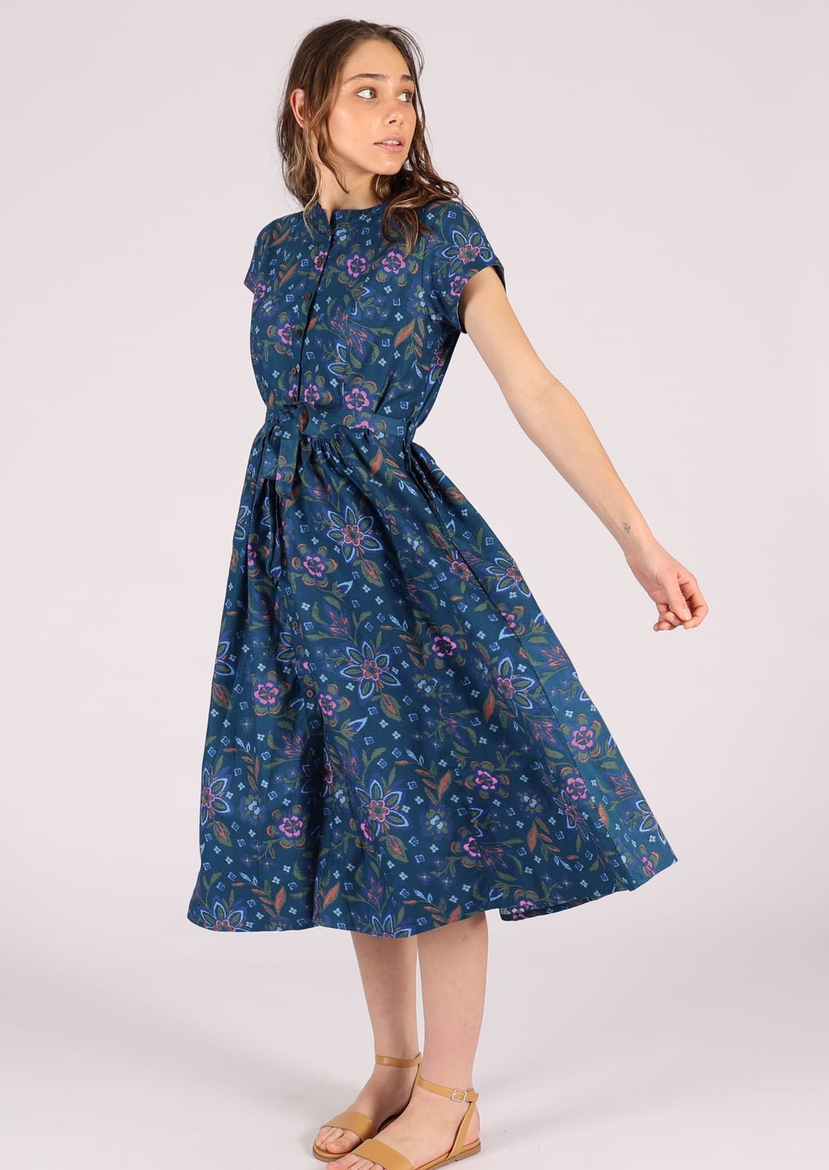 Model wears a 50's style cotton dress with short sleeves. 