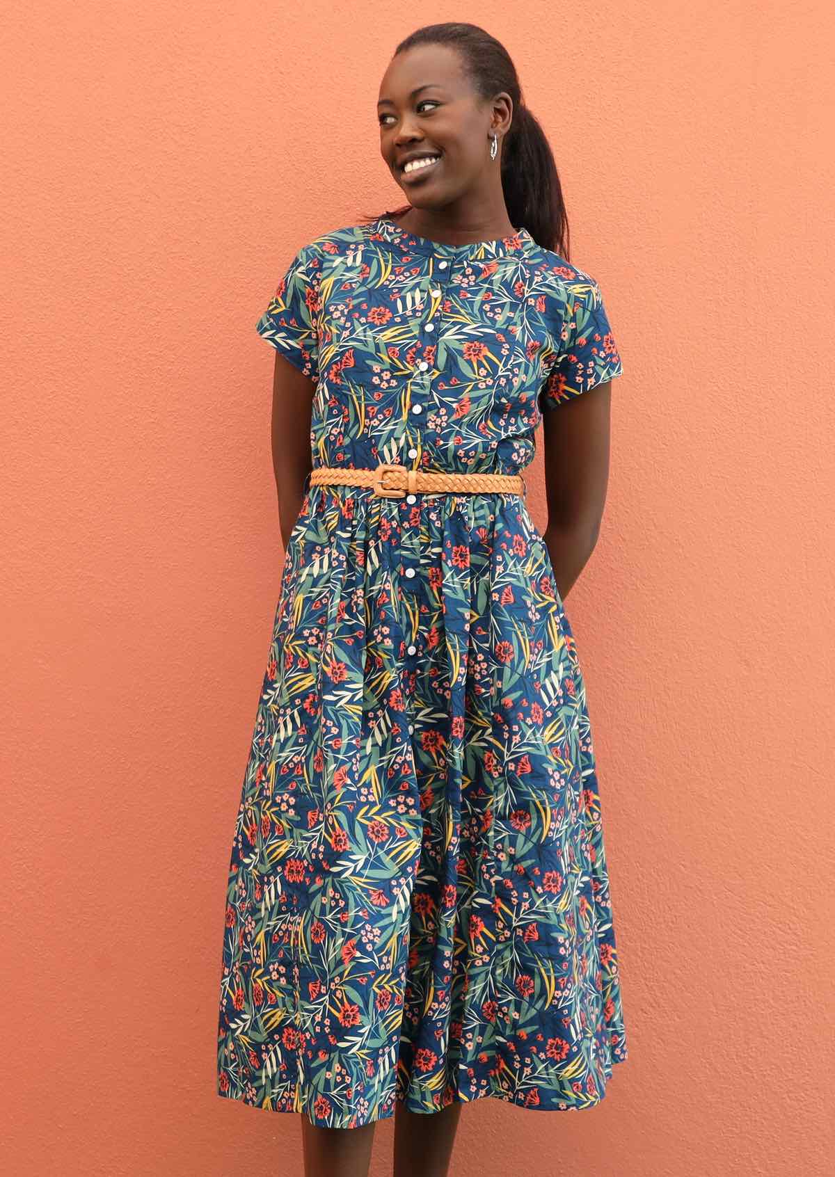 Model pairs 100% cotton dress with a belt and earrings. 