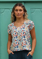Model wears floral cotton top with small pleats and buttons on front